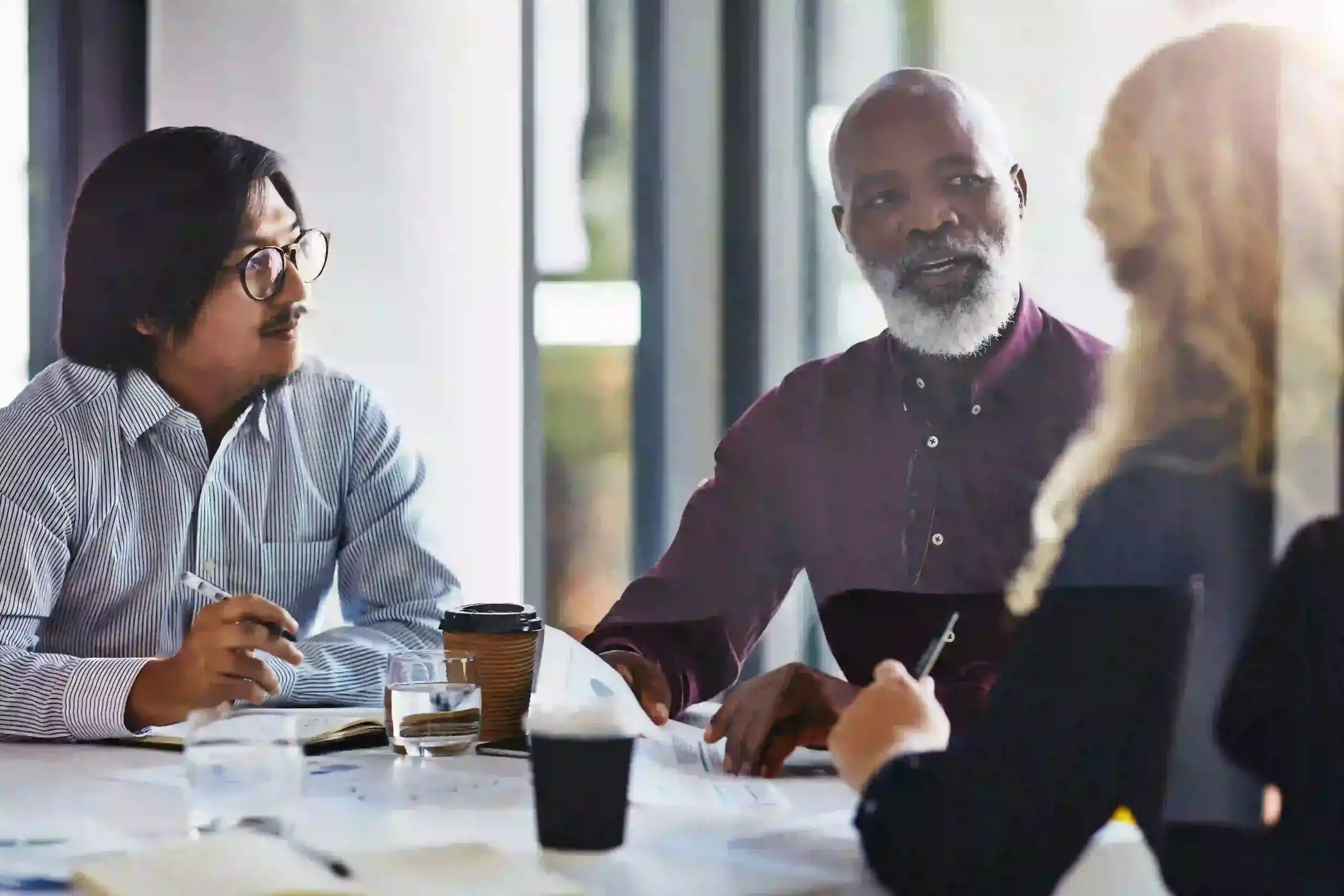 Diverse employees participating in a workplace meeting, representing workplace discrimination and employee rights issues.